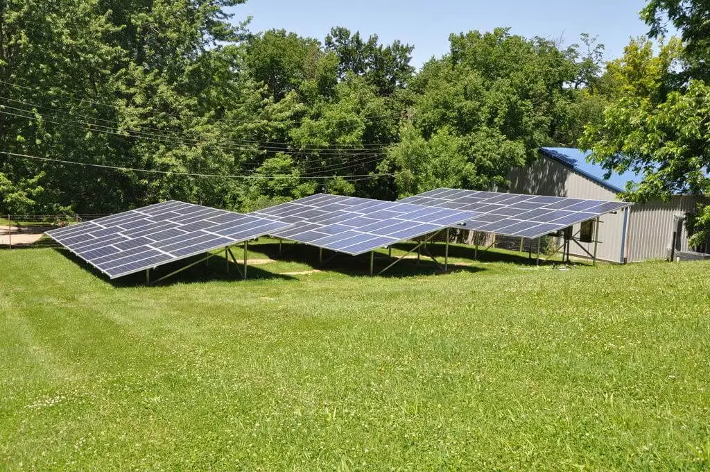 Solar panels on green grass field.