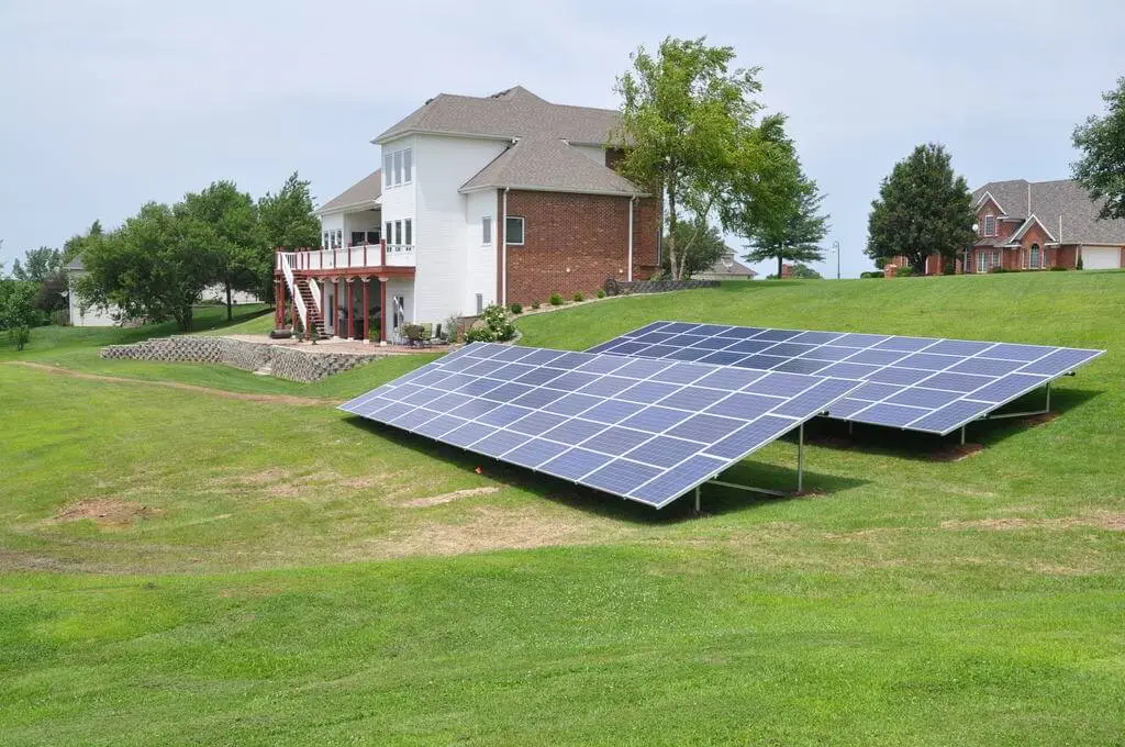 Solar panels on a grassy lawn.