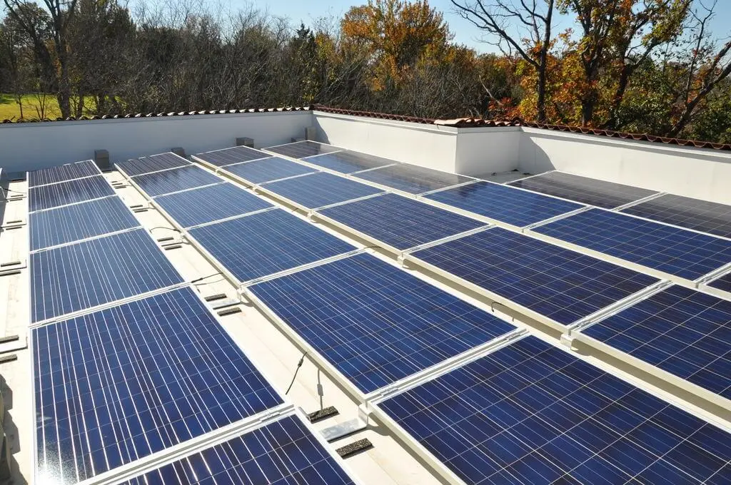 Solar panels on a white rooftop.