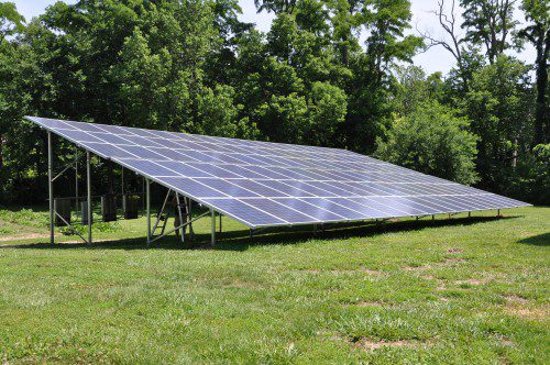 Solar panels on a metal frame in a field.