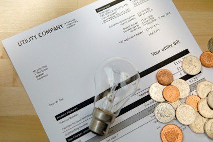 Utility bill with lightbulb and coins.