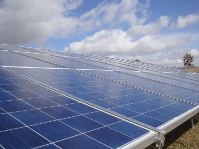 Solar panels under a cloudy sky.